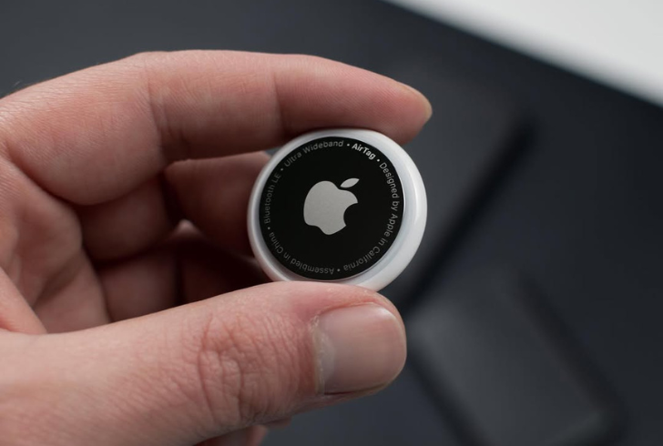 Person holding Apple AirTag